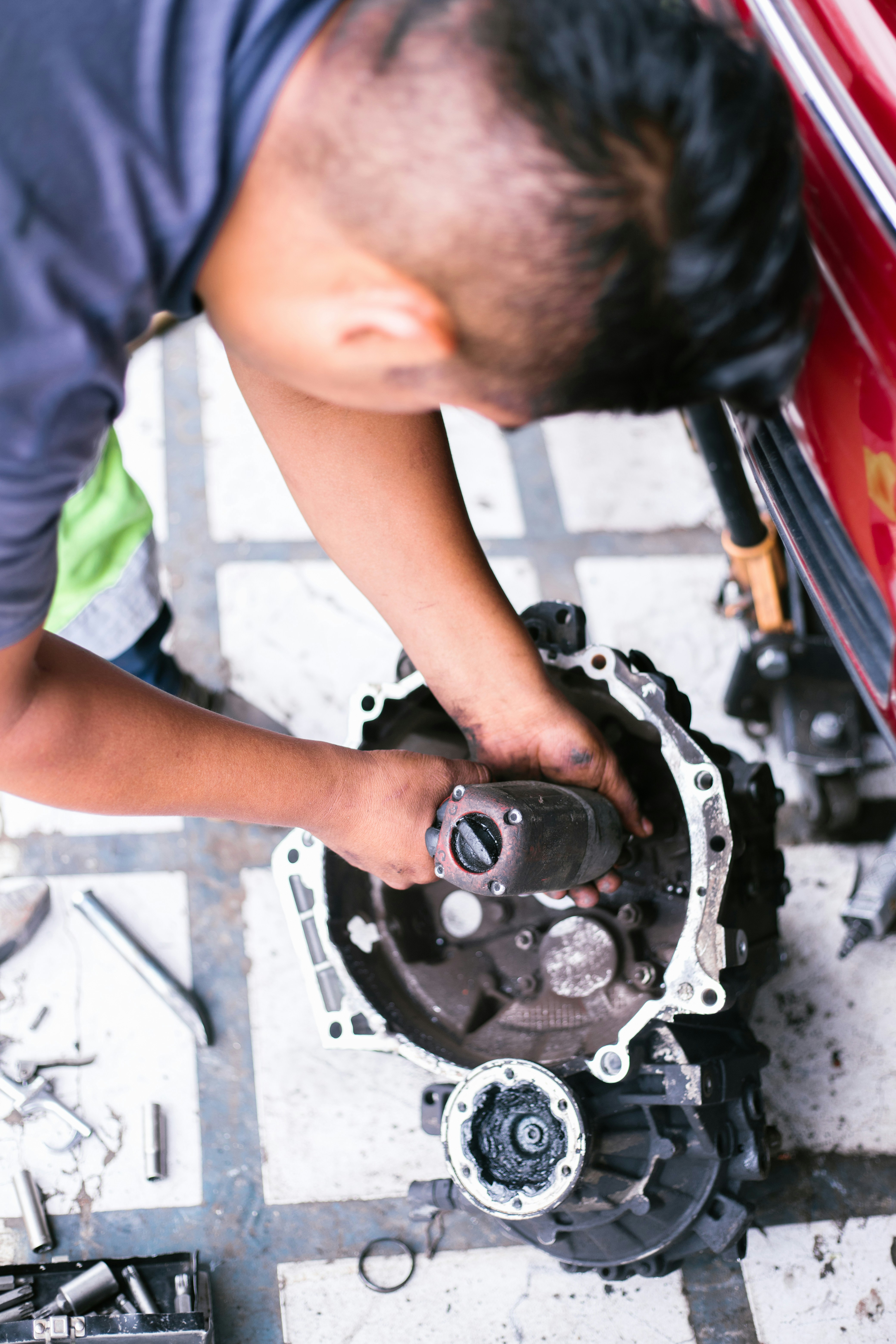 Mechanic performing transmission service